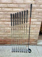 Full view of eight Callaway Diablo irons and one 3-wood standing upright