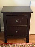 Front view showing two drawers with metal knobs