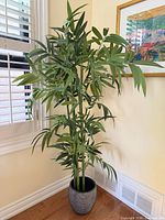 Full view of the faux bamboo tree in textured pot