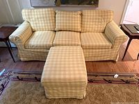 Front view of yellow check 3-seat sofa with ottoman
