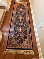 Full view of the rug runner showing entire length, pattern, borders and fringe
