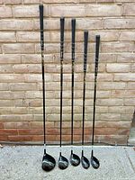 Five Tommy Armour clubs standing upright