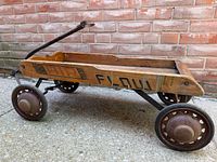 Full view of wooden wagon with metal wheels and handle