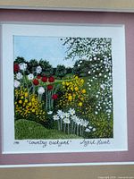 Close view of painting showing floral garden scene and signature
