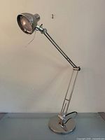 Full view of chrome articulating desk lamp