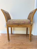 Side view of solid wood bench showing high slatted sides, legs and cushion