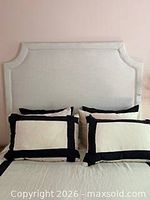 Front view of queen upholstered headboard mounted behind bed