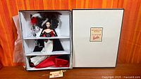 Barbie doll in open presentation box next to lid