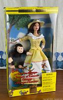 Front view of sealed Barbie and Curious George boxed set