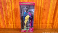 Front view of sealed box showing doll and attire