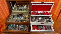 Overview of both jewelry boxes opened showing contents