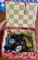 Open fabric box containing multiple wristwatches
