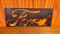 Full view of rectangular steel sign showing Ford script cutout