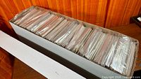 Full long box filled with bagged comics, lid removed