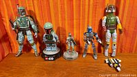Group shot of all figures and accessory lined up on wooden surface