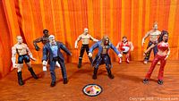 Group shot of all eight figures and pog on tabletop