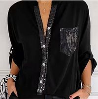 Front view of black blouse showing sequin placket, pocket and rolled sleeve