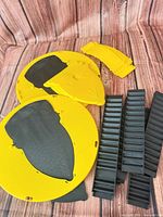 Yellow circular lids and black ramp inserts laid out