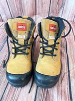 Front view of pair of tan Aggressor work boots showing laces and toe caps