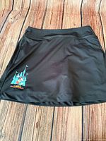Full view of black skort front with graphic