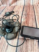 Garmin GPS with charger cable and weighted dash mount