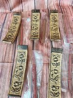 Group of five ceramic incense holders with sealed incense sticks