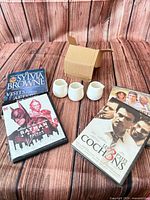 All items grouped: book, three DVDs, three creamers beside packing box