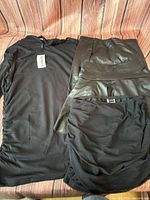 All three black garments laid flat: Zeagoo top with tag, faux-leather skirt, ruched bandeau