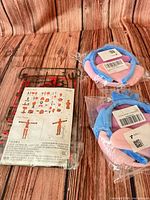 Lot overview showing model kit sprues pack and two sealed plush headbands