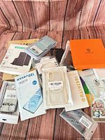 Group shot of all packaged phone cases, screen protectors, watch bands and wallet cases