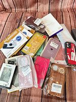 Overview of mixed phone cases, EMF sticker boxes, lanyard strap packaging