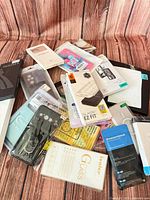 Top view of all packaged cases and screen protectors spread on wood background