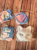 Overview of three sealed plush headbands and white cat mask