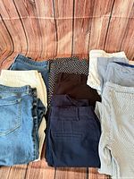 Overview of all nine pairs of women’s pants laid out in three columns