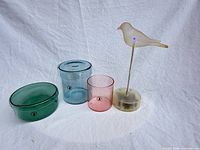 All three pastel glass containers and bird LED light grouped on white background