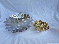 Silver stainless and gold brass-tone bowls side by side