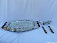 Tray, nine glasses, jigger and spoon displayed together