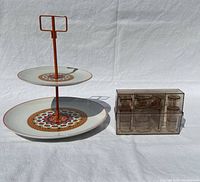 Two-tier tray and canapé mold set side by side