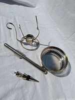 set laid out showing stopper, thermometer in sheath, stand, pierced coaster