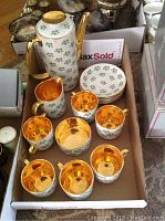 Full tea set with teapot, creamer, sugar bowl, 6 teacups and 6 saucers displayed in a cardboard box.