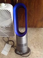 Both the Classic box fan and the Dyson Hot+Cool fan side by side on floor