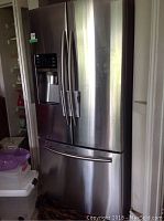 Front exterior view of stainless steel French door refrigerator with bottom freezer drawer