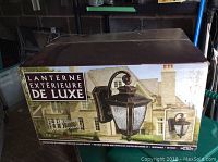 Box of a Lanterne Extérieure De Luxe exterior coach light showing lantern style and packaging details