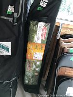 Coeman canopy packed in a black bag showing branding and product details on label.