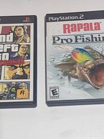 GTA Liberty City Stories and Rapala Pro Fishing PS2 cases front view