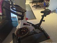 Left side view of Chaoke 8733 spin bike showing flywheel shroud, frame and saddle
