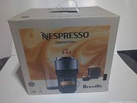 Front of original Nespresso Vertuo Pop+ box with branding and model image