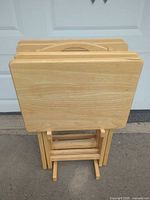 Front view of four folded trays on stand