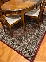 Full view under dining table showing overall rug size and pattern