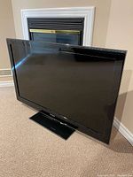 Front view of Samsung flat screen TV on pedestal stand
